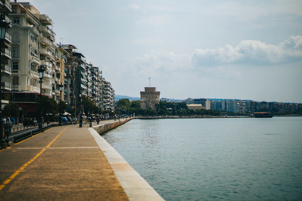 a view of a body of water next to a row of buildings