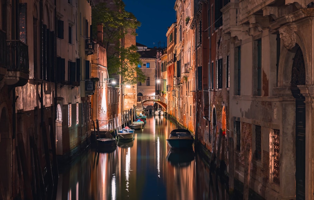 a narrow canal in a city at night
