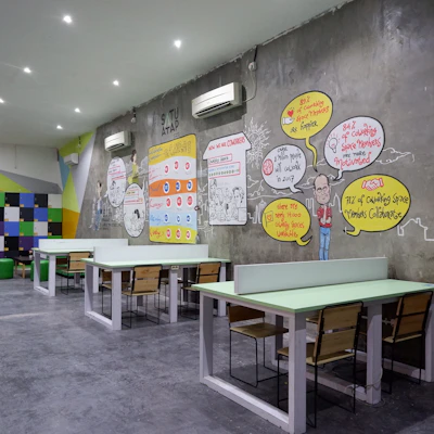 Modular acoustic partition panels in a collaborative coworking space.