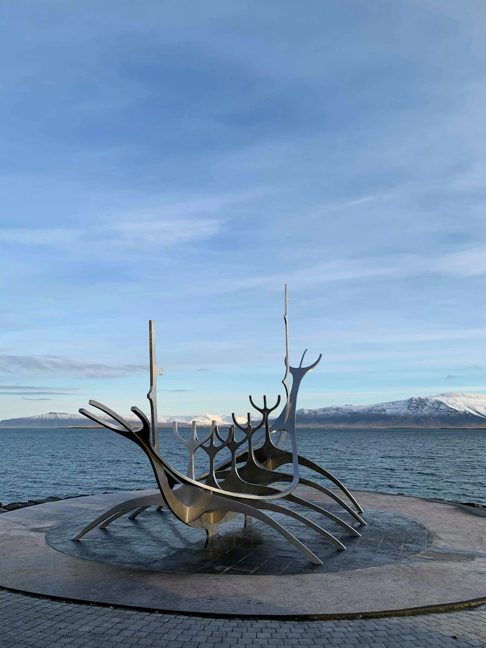 a large metal sculpture sitting on top of a cement slab