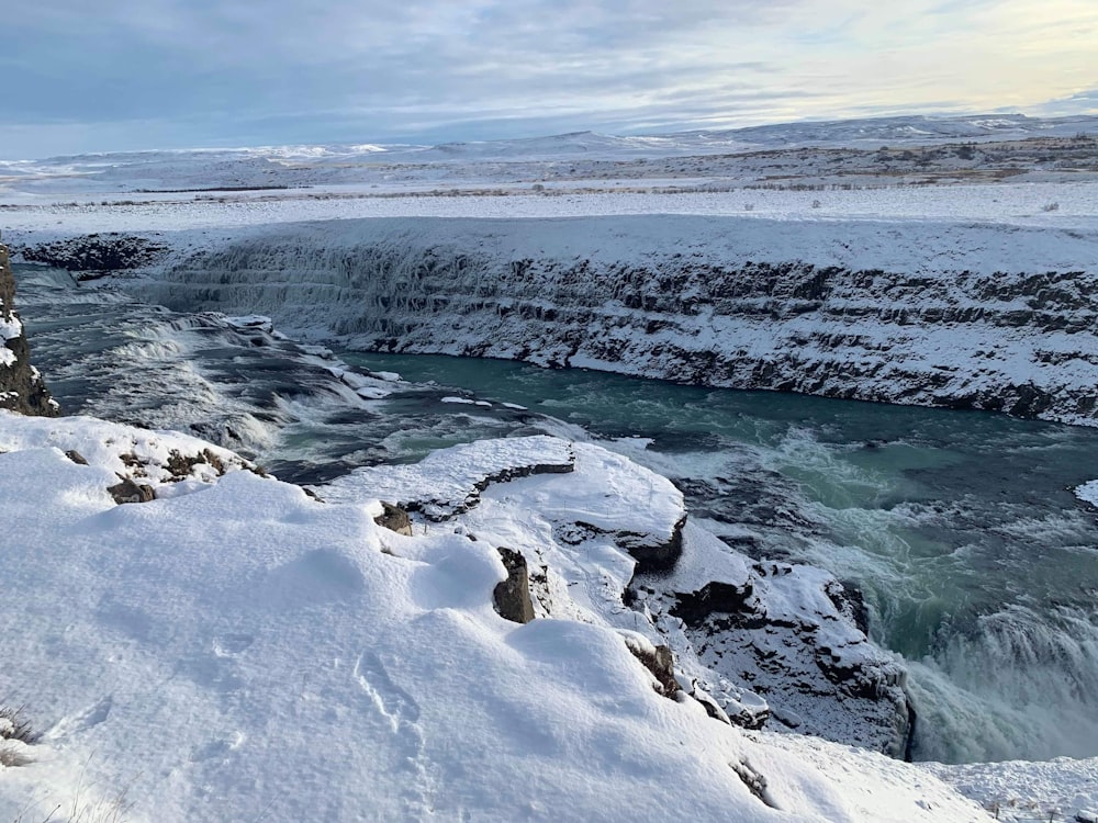 a man standing on a cliff overlooking a river