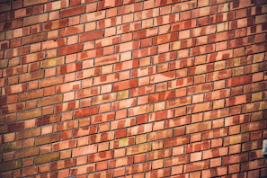 Close-up of warm red natural clay brick cladding on a modern villa exterior in Bangalore