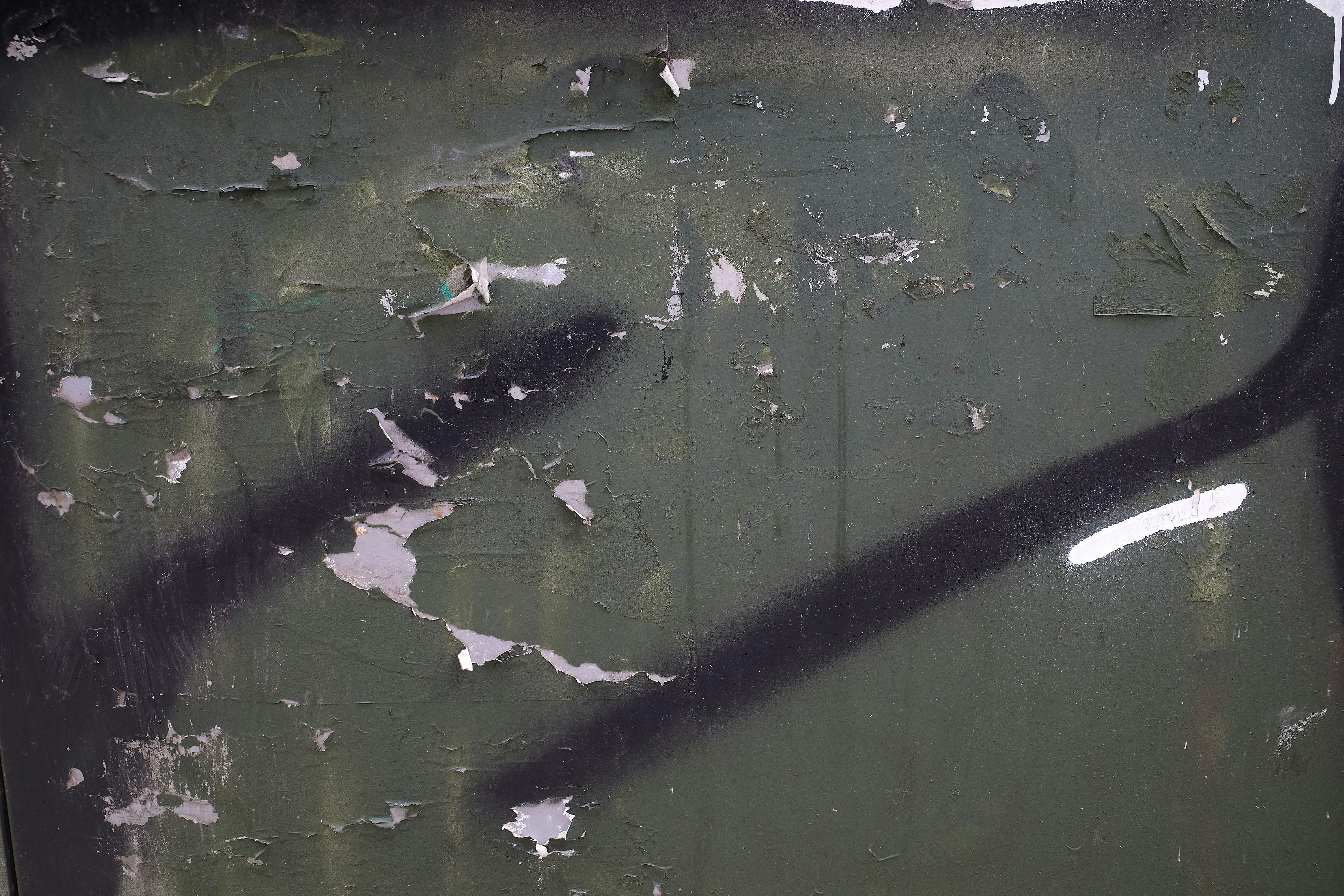 a close up of a street sign with graffiti on it