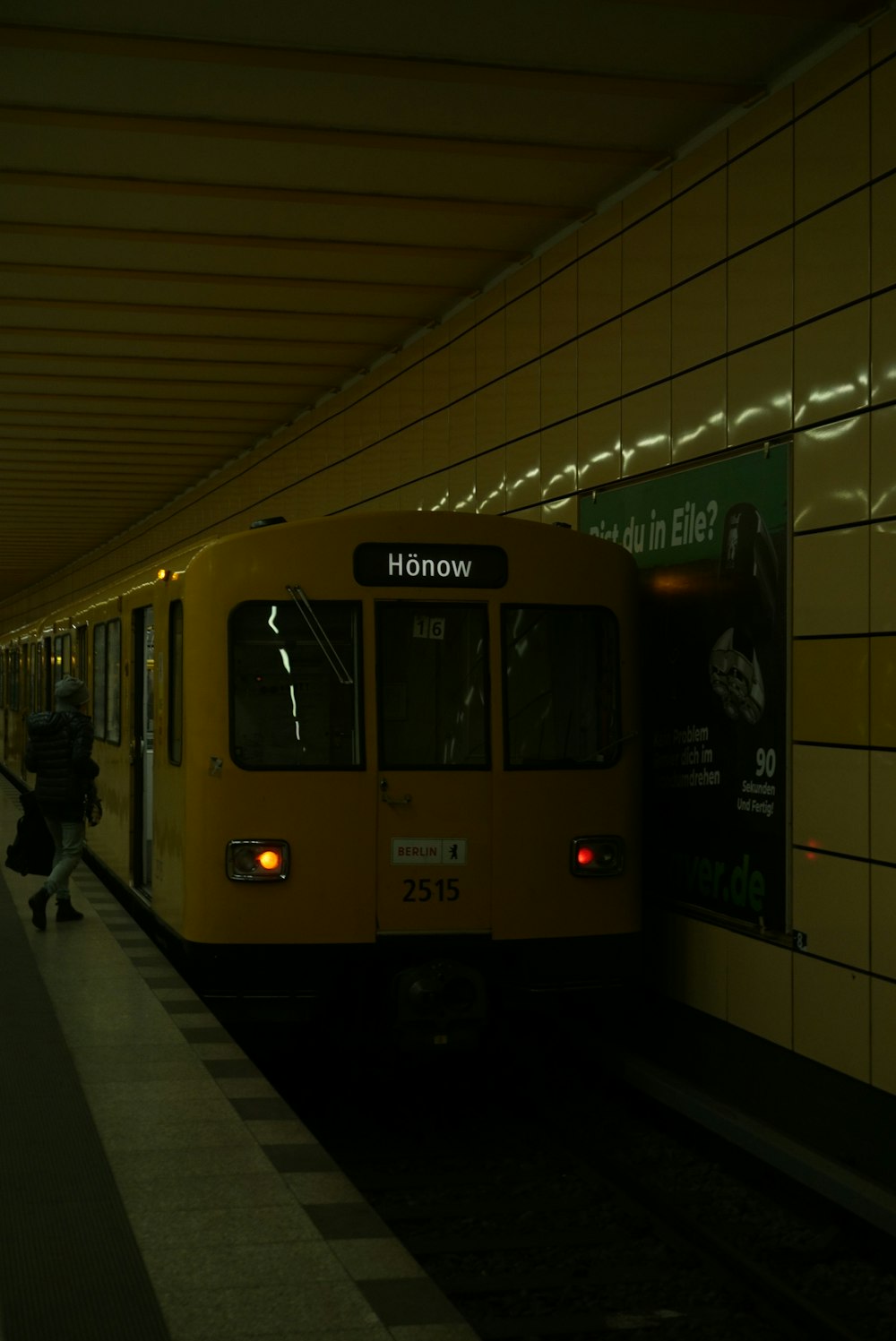 a yellow train pulling into a train station