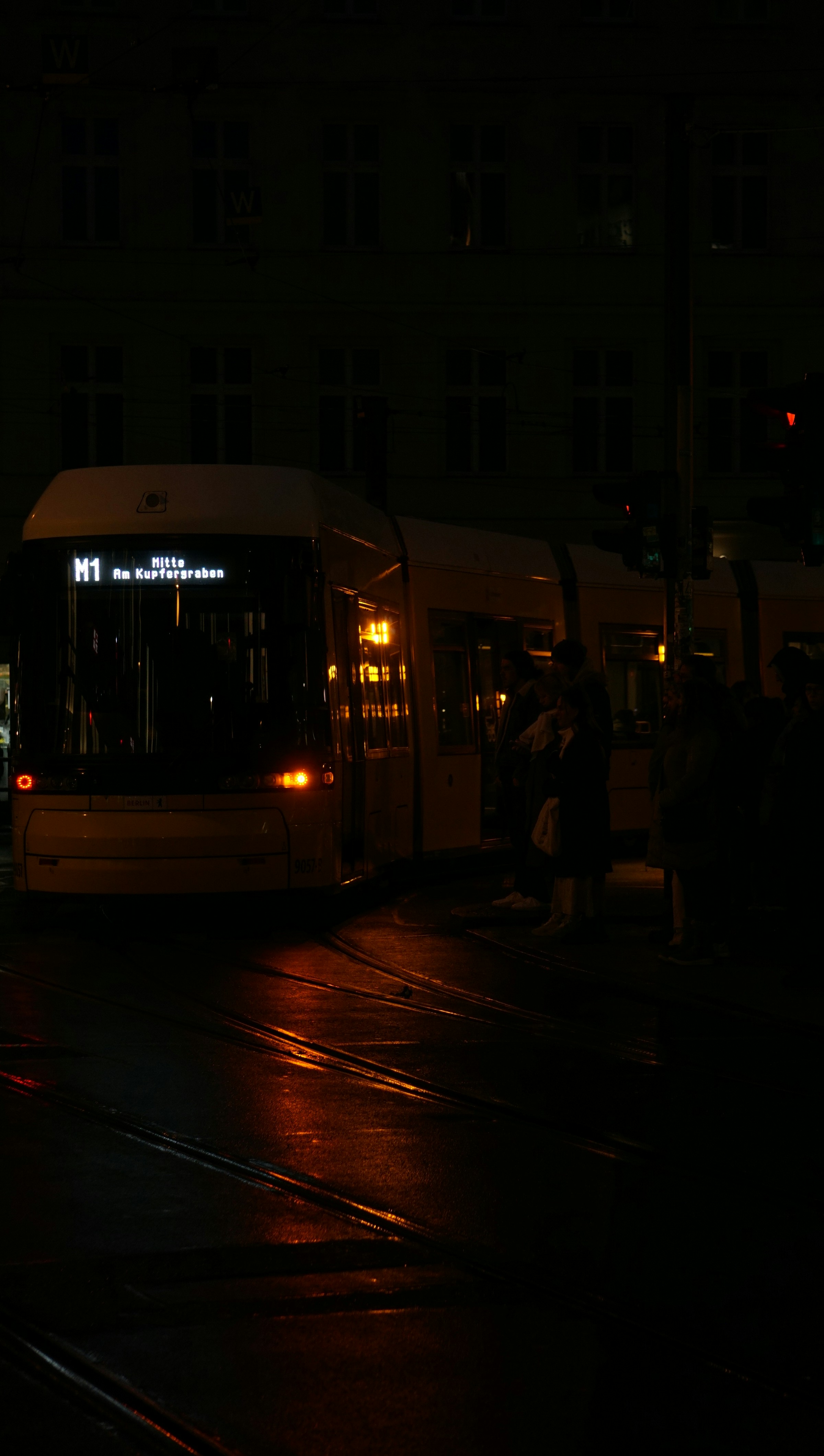 a bus driving down a street at night