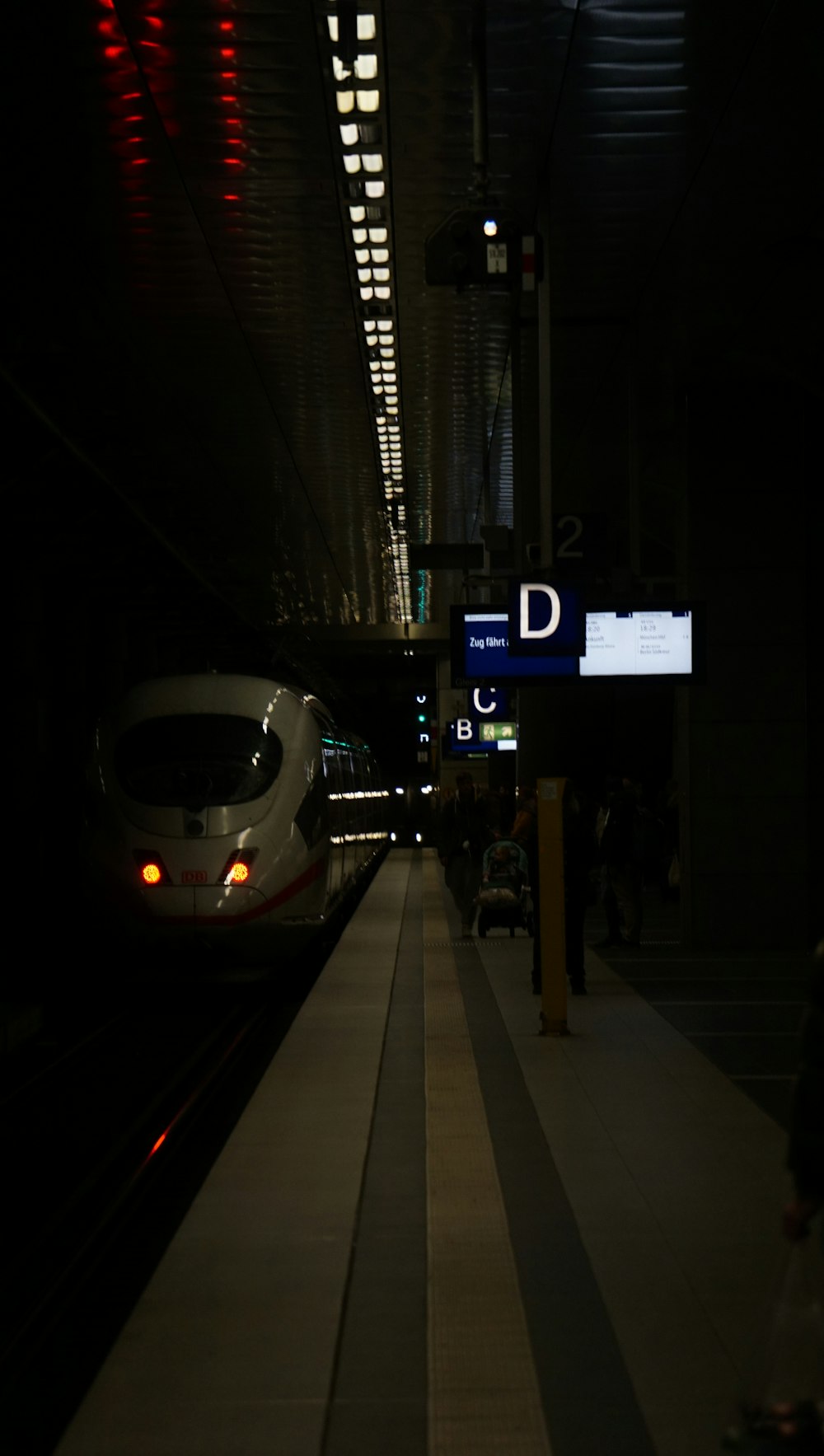 a train traveling down train tracks next to a platform
