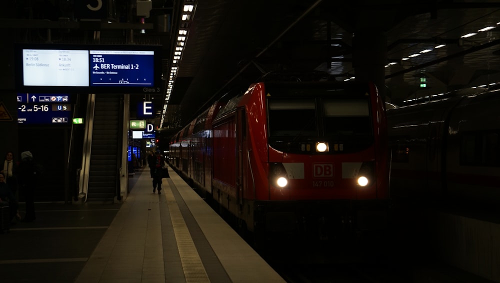 a train pulling into a train station at night