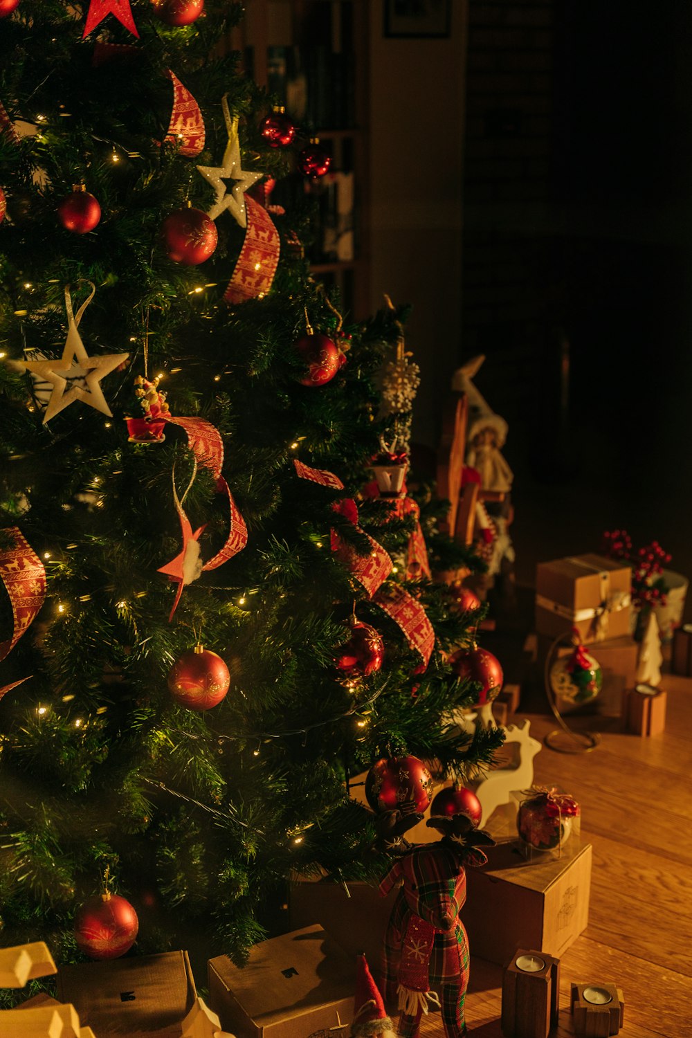 a christmas tree is decorated with red and gold ornaments