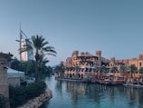 a body of water surrounded by buildings and palm trees