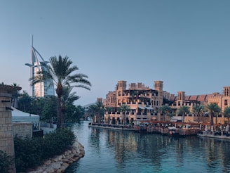 a body of water surrounded by buildings and palm trees