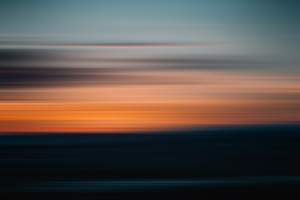 a blurry photo of a sunset with a sky in the background