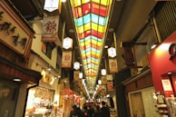 a group of people walking down a long hallway