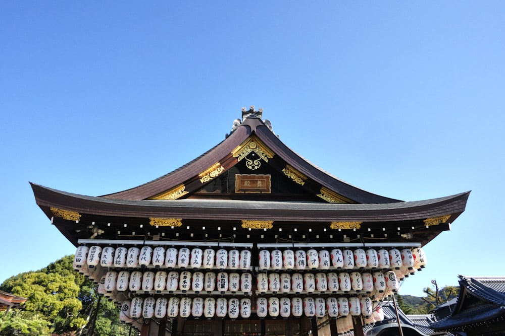 a tall building with lots of bottles hanging from it's roof