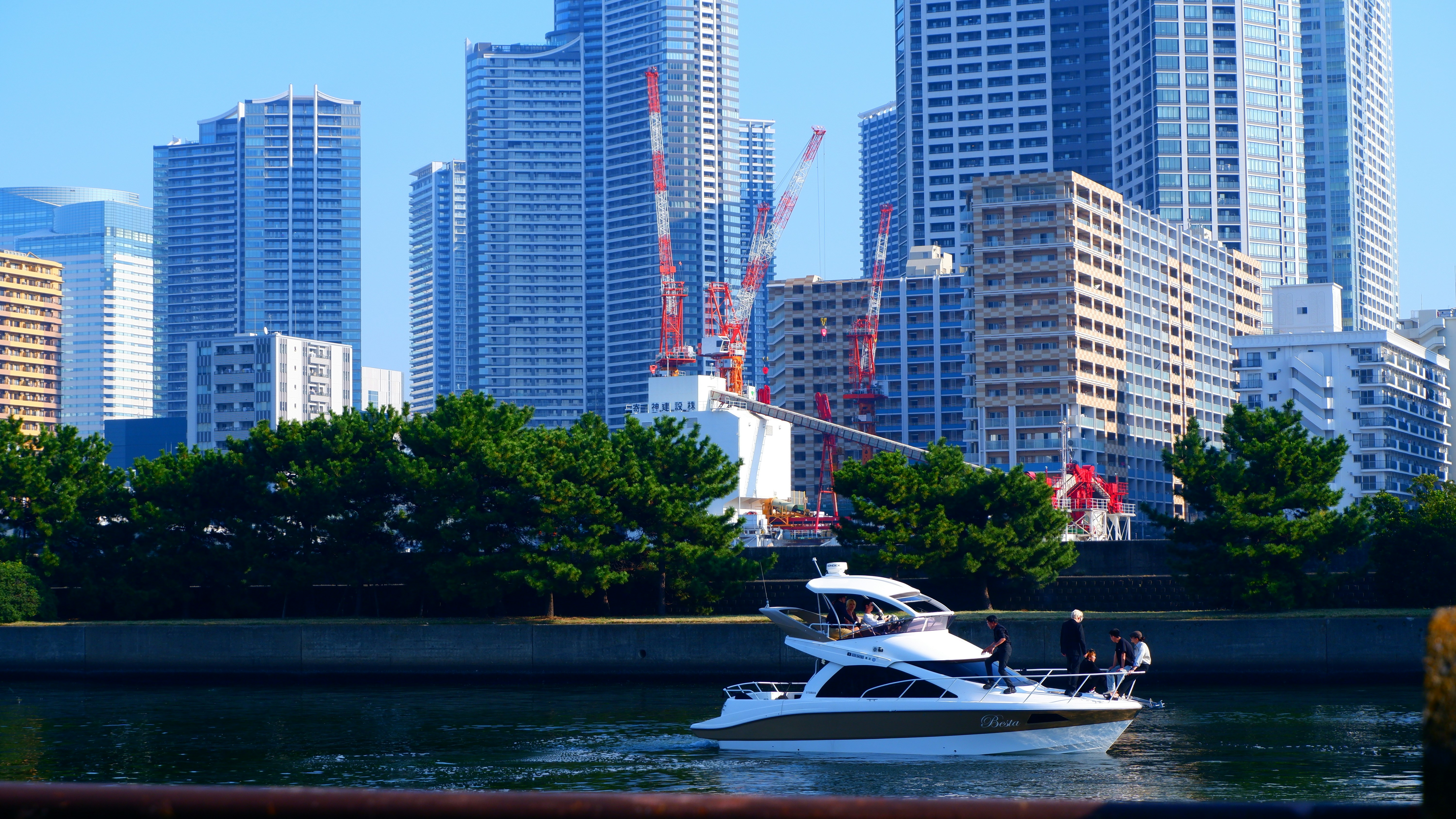 a boat in the water with a city in the background