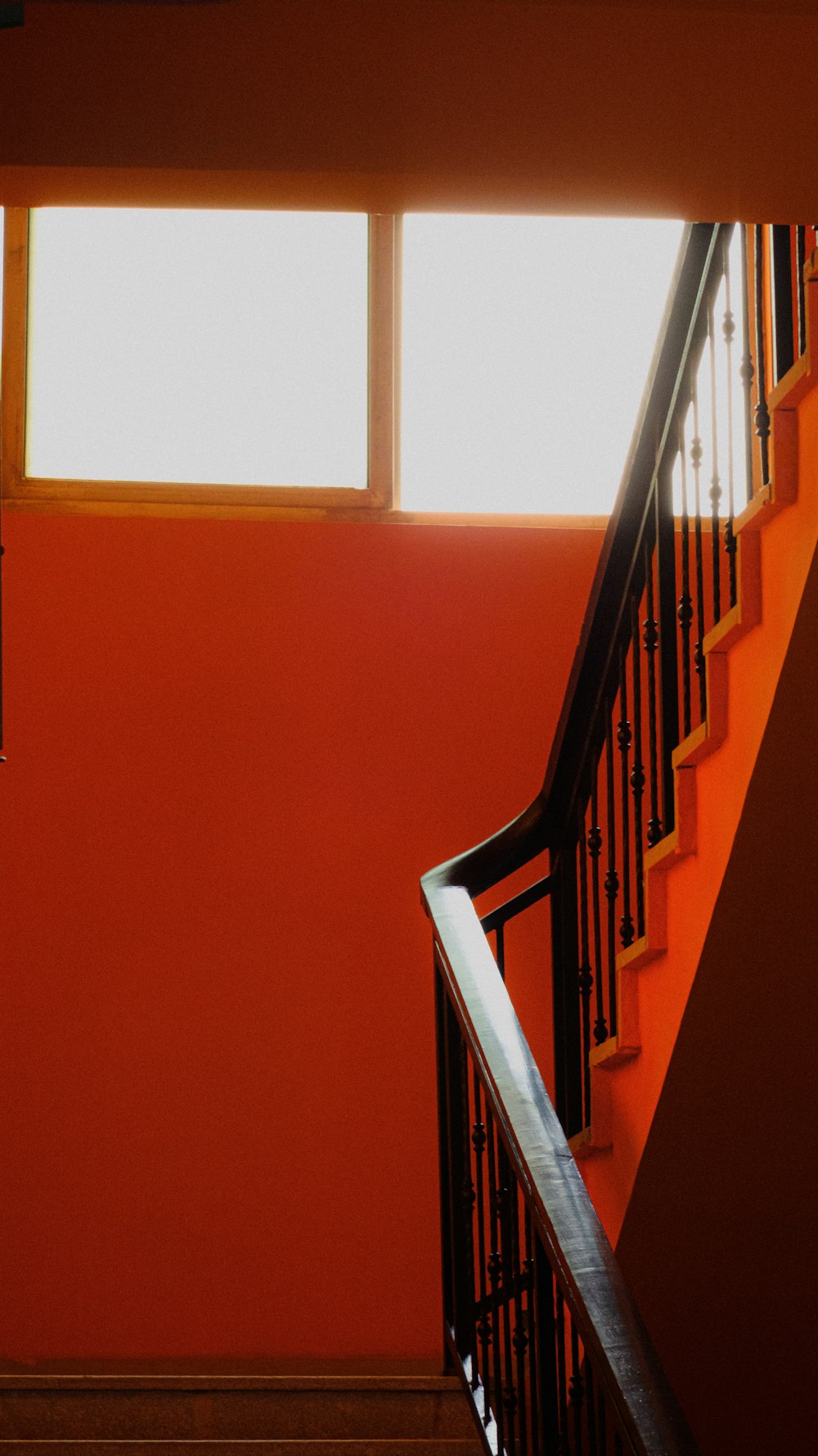 a stair case with a clock on the side of it