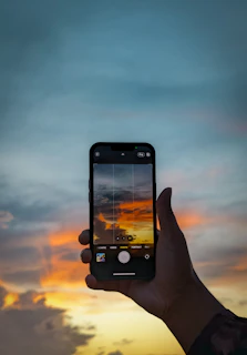 A mobile phone screen displaying snapedit’s filter options applied to a sunset photo.