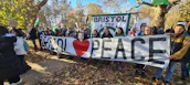 A group of activists holding banners calling for peace in Iran.