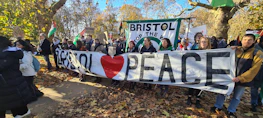 A group of activists holding banners calling for peace in Iran.