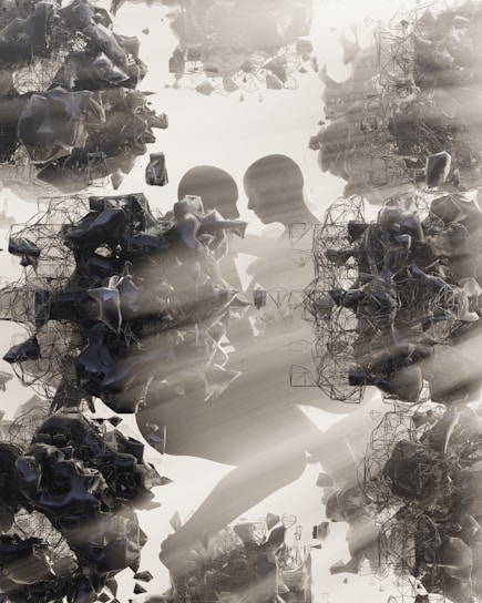 Abstract human figures are intertwined with complex, dark, geometric shapes and structures. There is a play of light and shadow, giving a sense of depth and texture. The overall composition has a surreal and futuristic appearance.