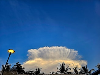 A dramatic photo of a mushroom cloud rising over a Pacific island during a nuclear test.