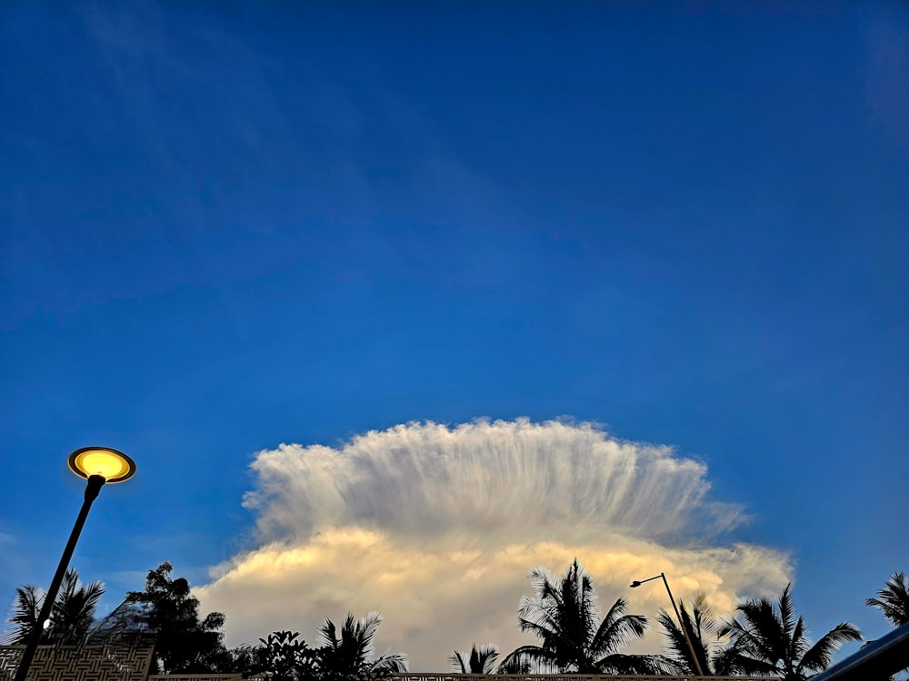 a cloud is in the sky above a street light