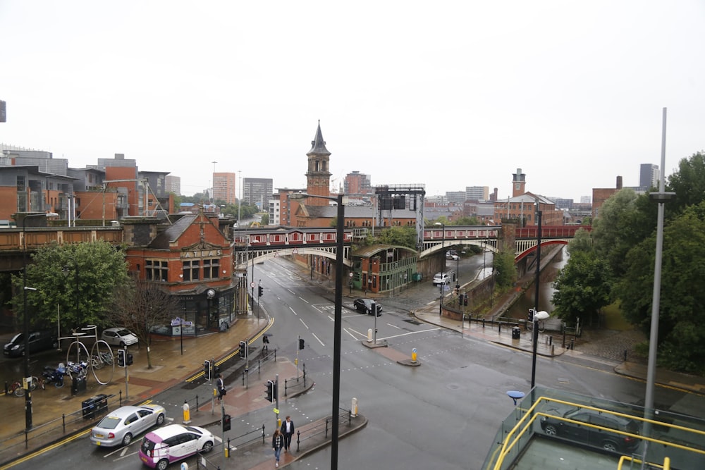 a view of a city street with a bridge in the background