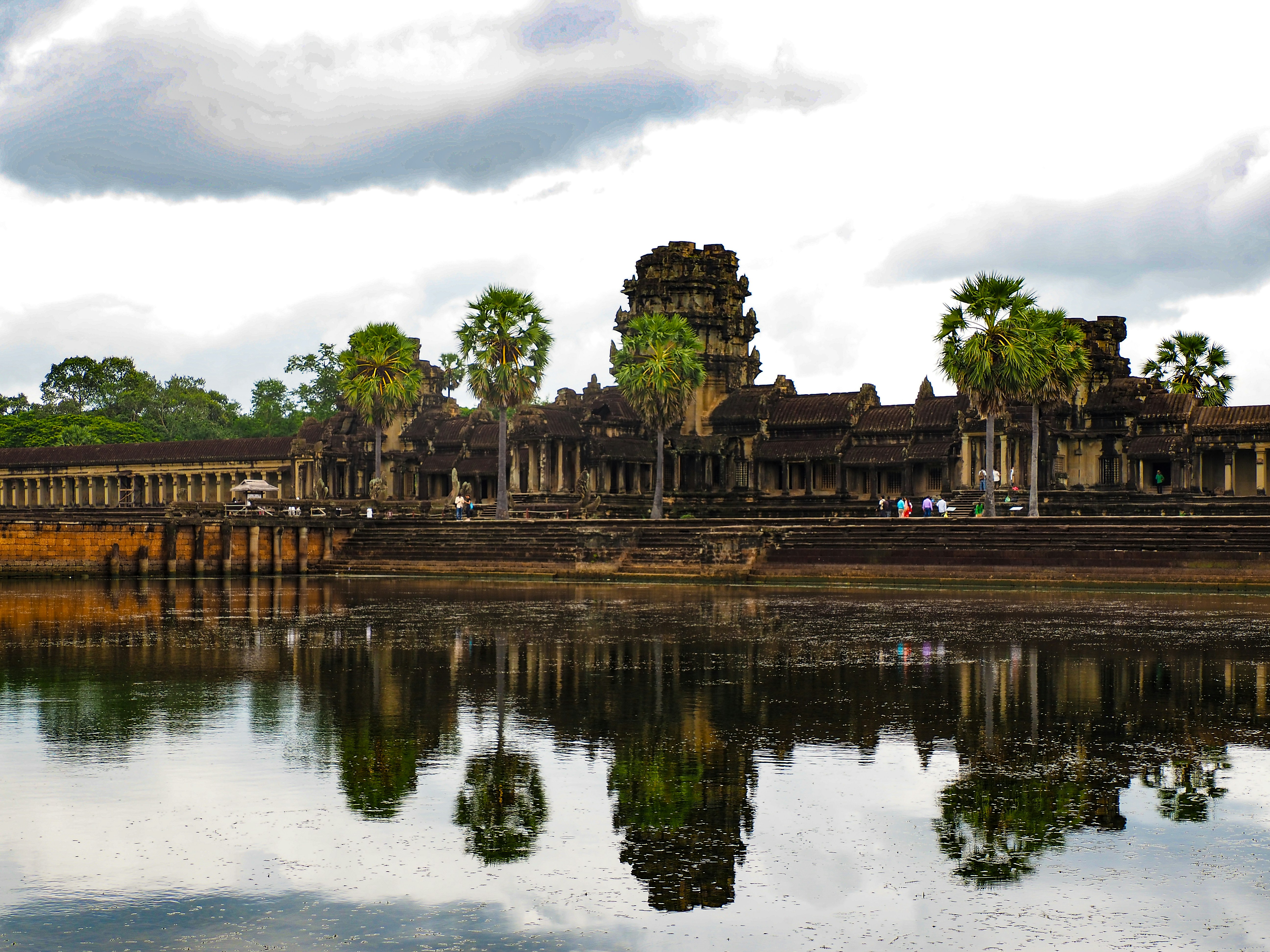 a large body of water with a building in the background, 