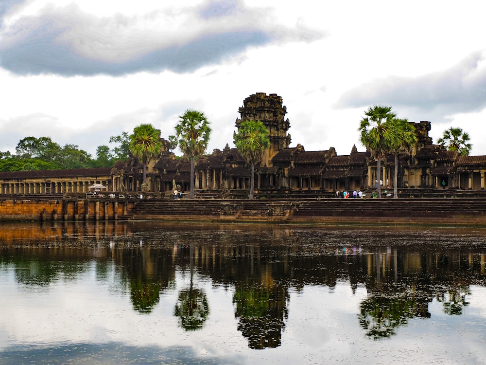 a large body of water with a building in the background