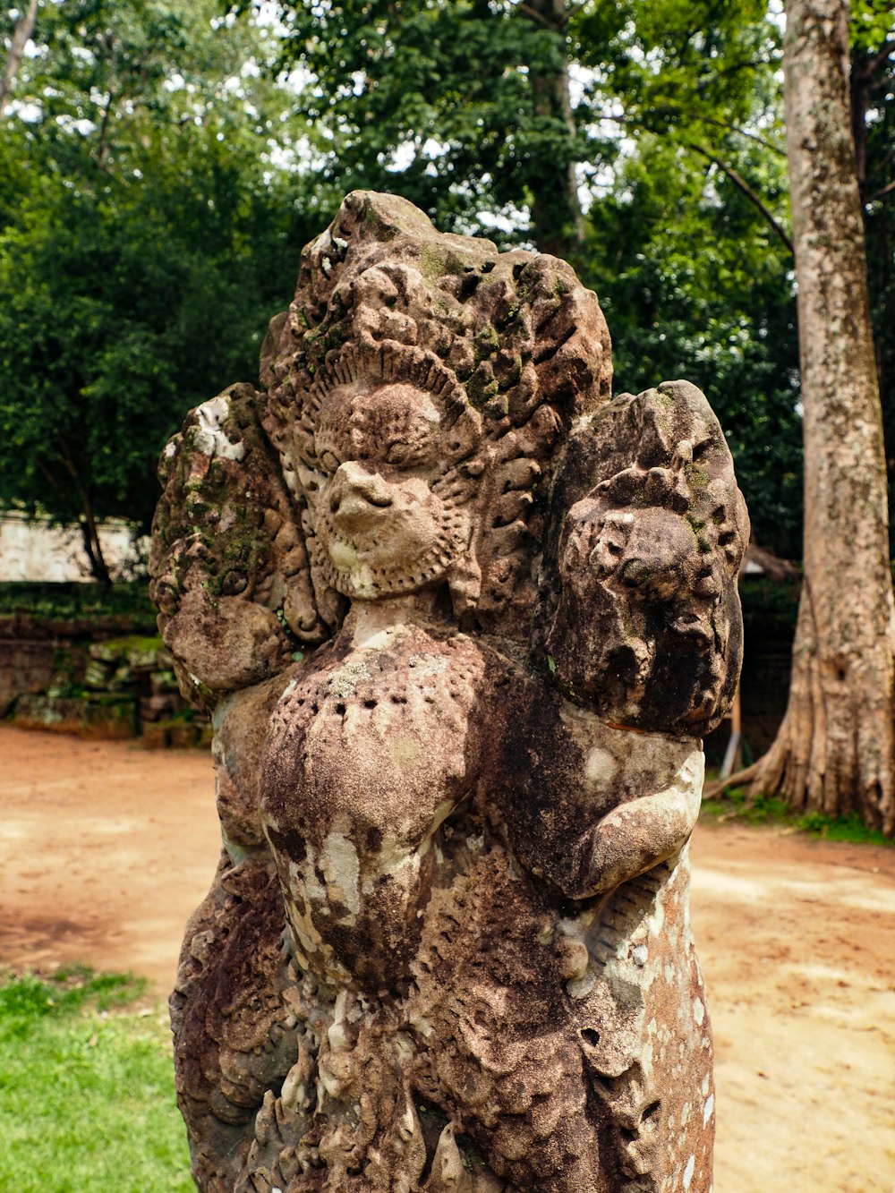 a stone statue of a man holding a woman's head