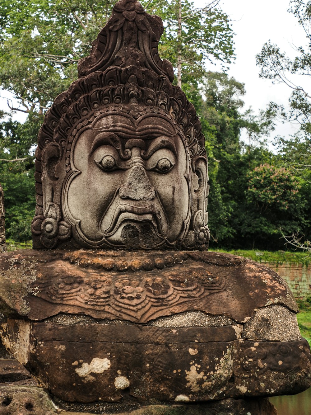 a stone statue with a face on top of it