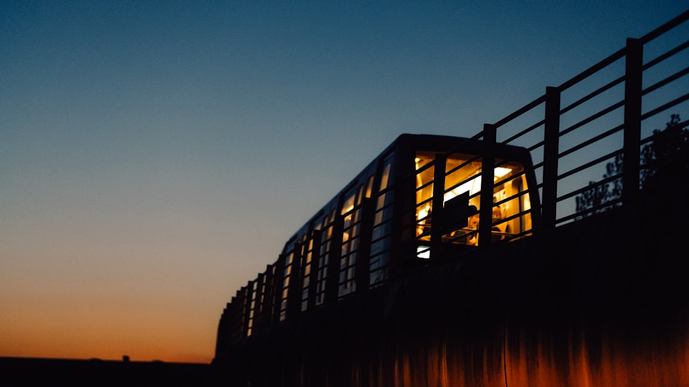 a person standing on top of a bridge at night