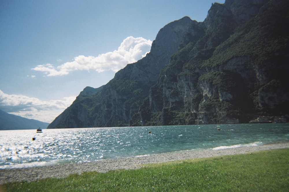 a body of water with a mountain in the background