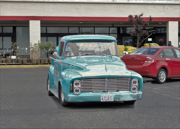 A turquoise and silver delivery truck parked outside the a & f logistics Altona office.
