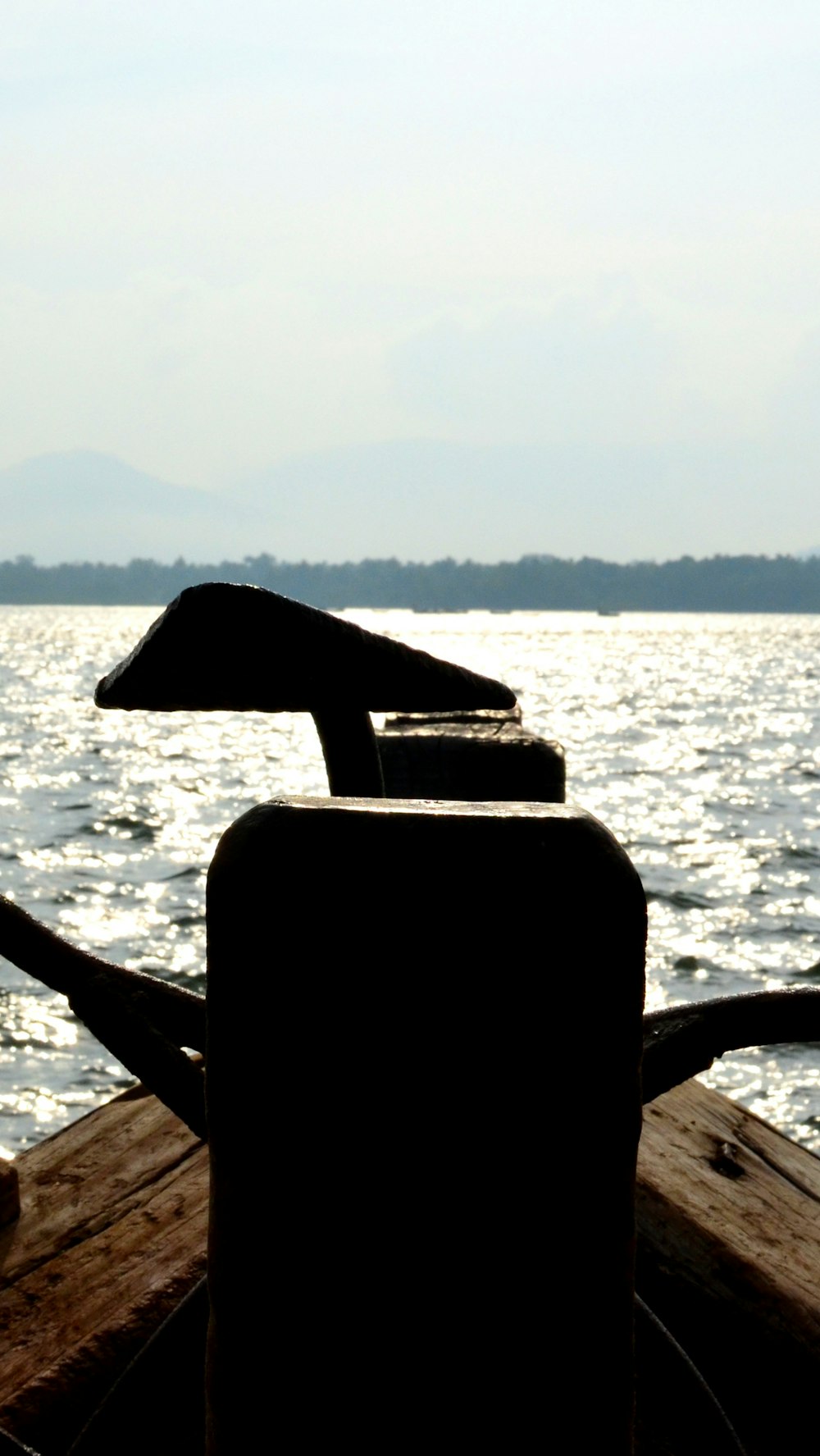 a chair sitting on the side of a boat in the water
