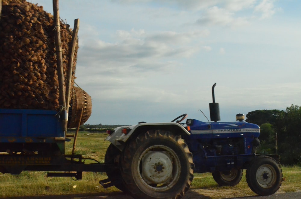 a tractor pulling a trailer full of hay