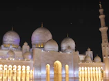 Spacious Fairmont Clock Tower room overlooking the Grand Mosque with warm ambient lighting.