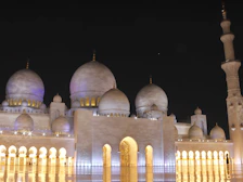Spacious Fairmont Clock Tower room overlooking the Grand Mosque with warm ambient lighting.