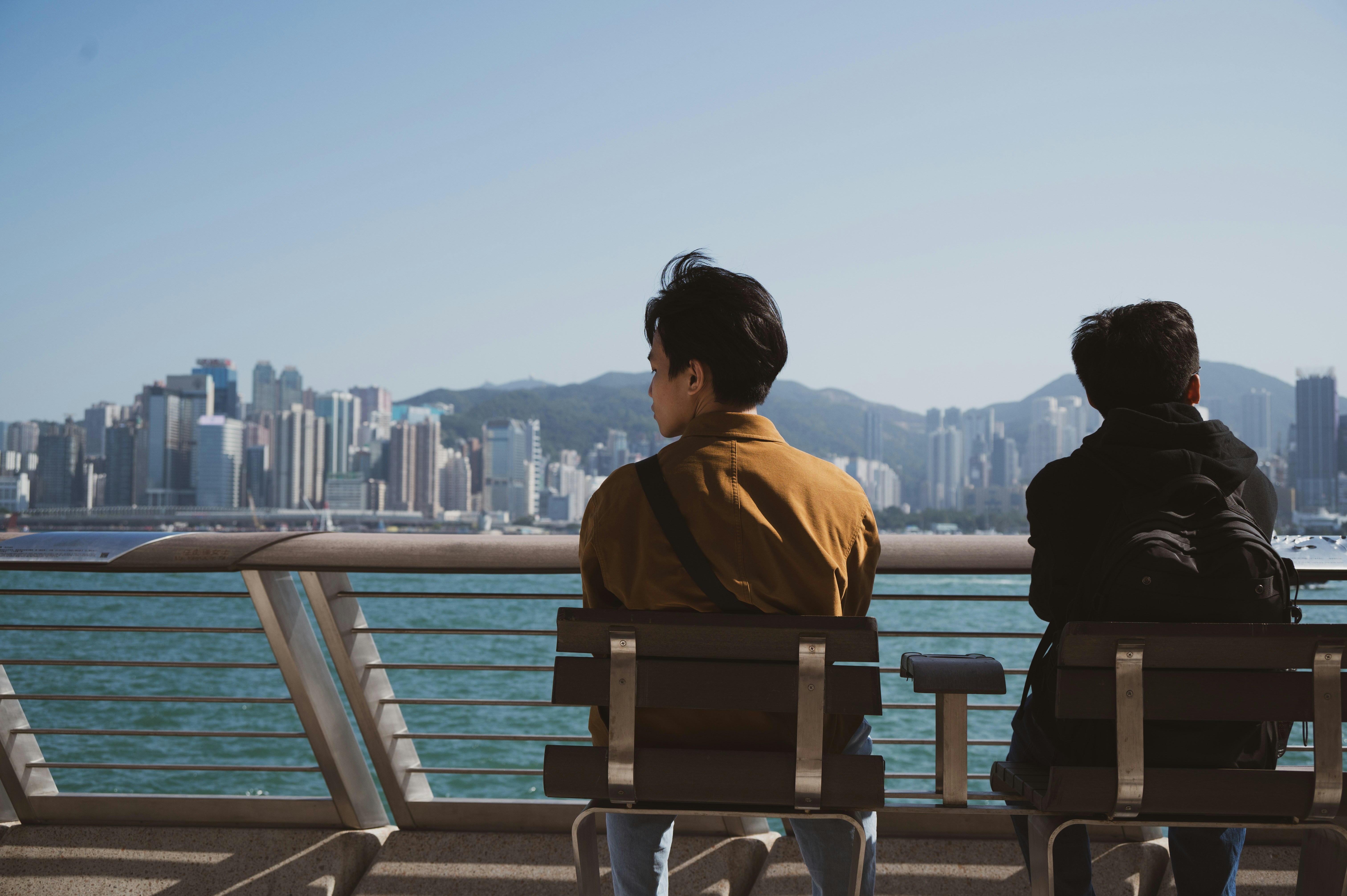 a couple of people sitting on top of a bench