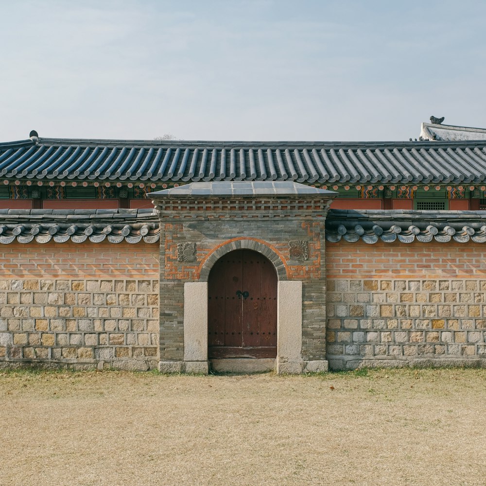 a brick building with a door and a roof