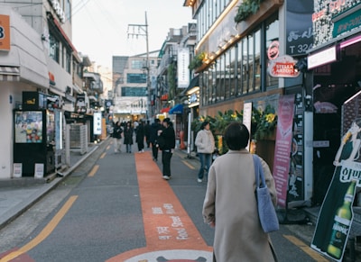A busy neighborhood street with shops.
