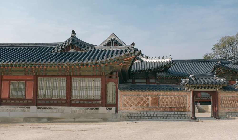 a building with a lot of windows and roof tiles