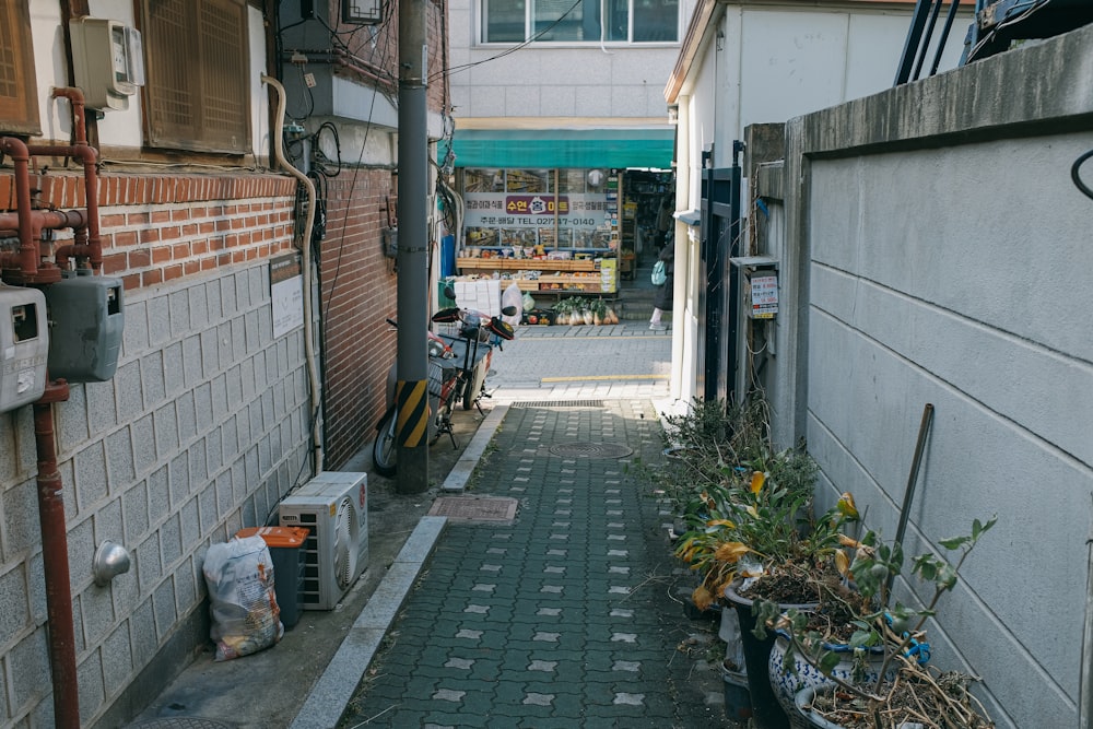 a narrow alley with a bicycle parked on the side