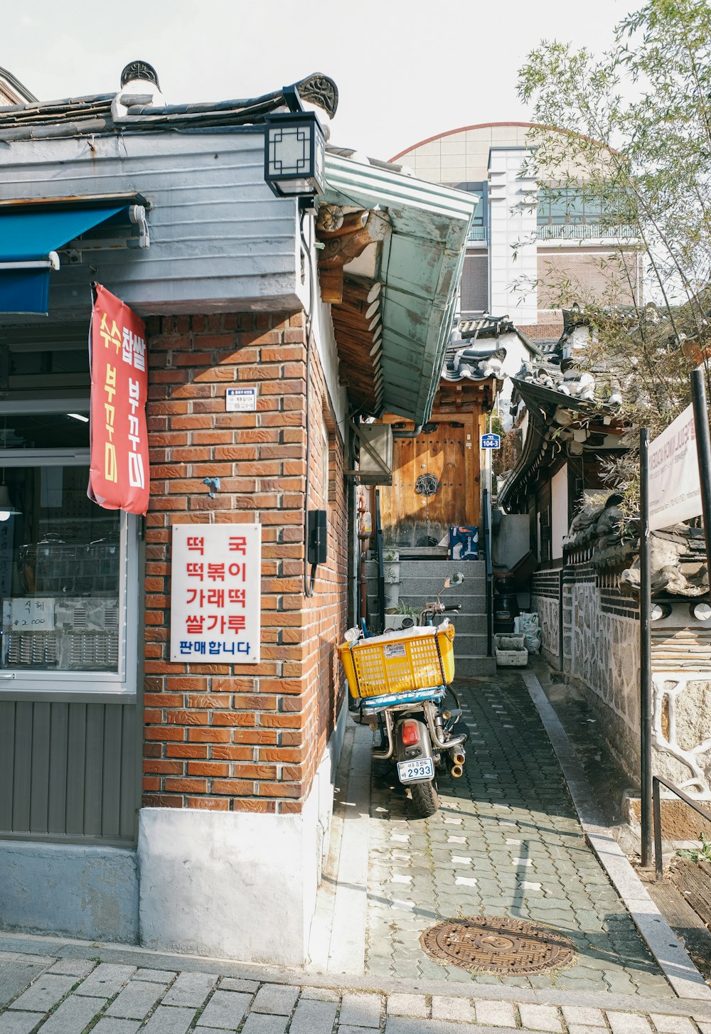 a brick building with a yellow cart parked in front of it