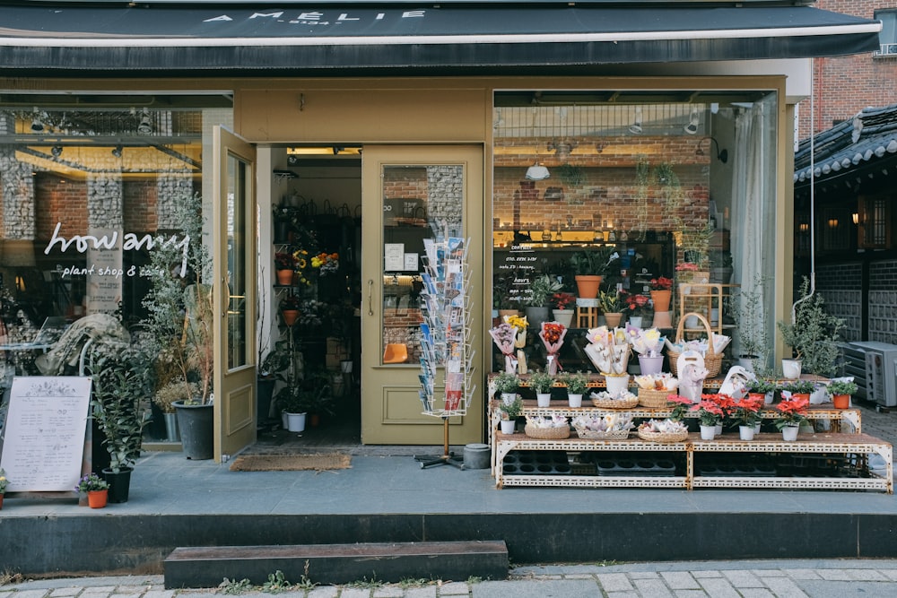 a flower shop with lots of flowers in front of it