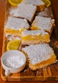 Homemade lemon energy bars wrapped in parchment paper on a kitchen counter.