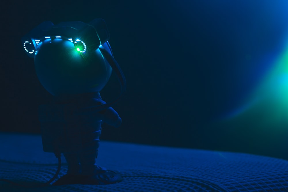 a stuffed animal with glowing eyes on a bed