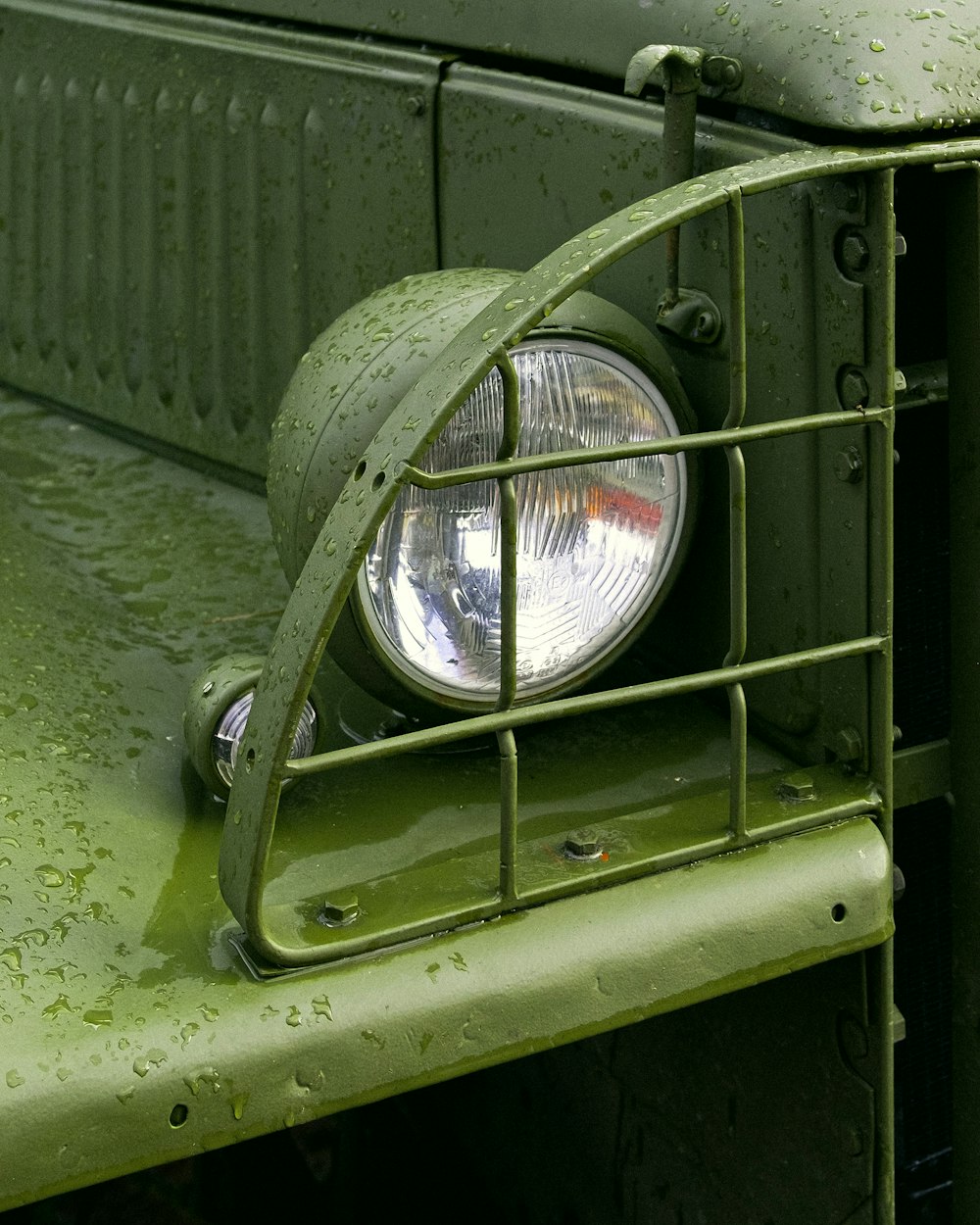 a close up of a light on a green truck