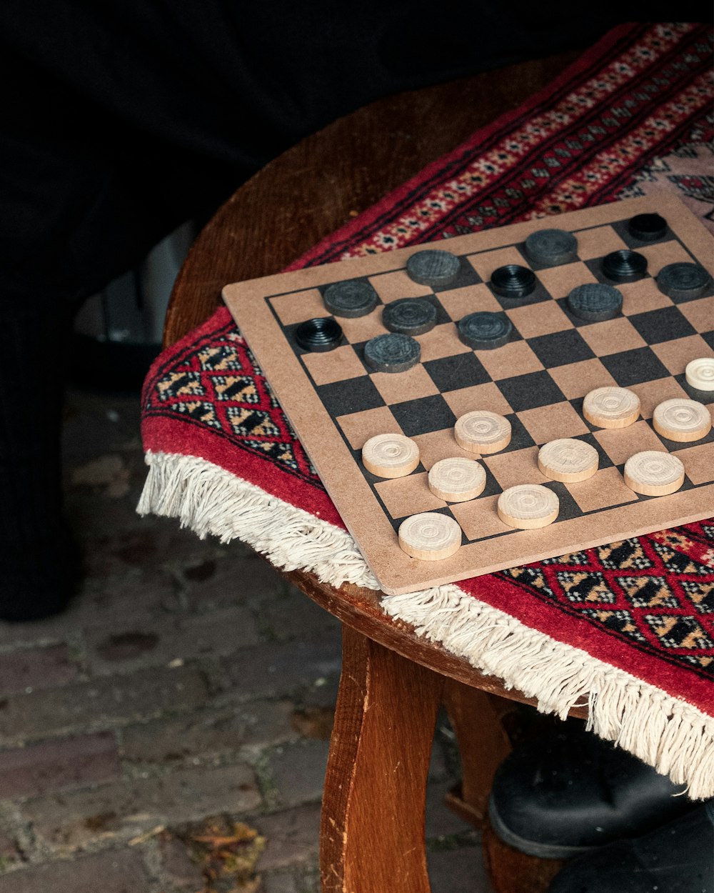 a wooden chess board sitting on top of a table
