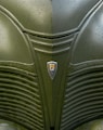 a close up of a green car with a badge on it