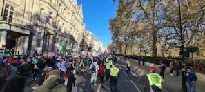 A peaceful protest with people marching down a city street.